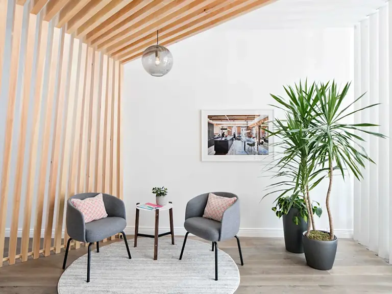 Kip and Tam Barnard Group, San Jose real estate Wooden beams partition with chairs and plants 1.